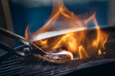 Flipping burger on barbecue