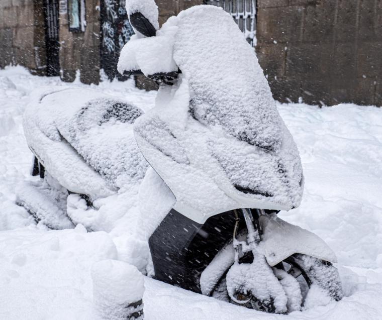 Motorbike covered in snow. 