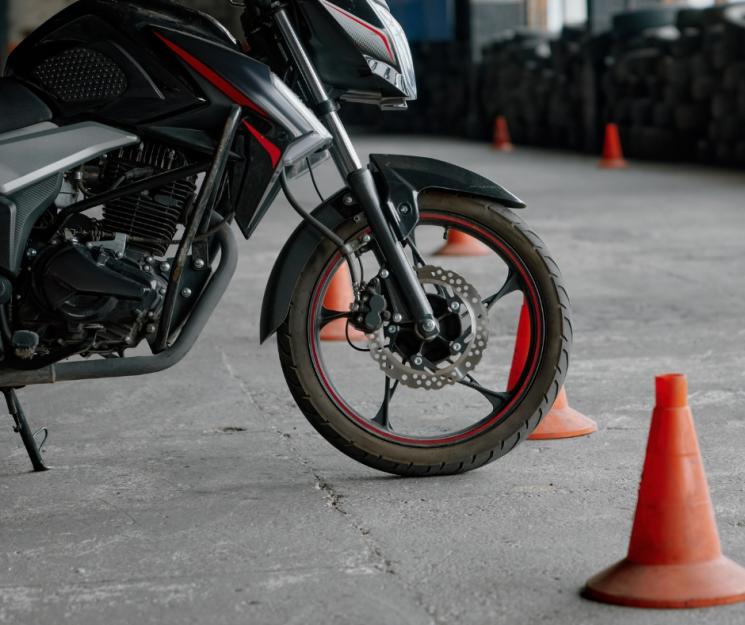 A motorbike front wheel in-between two cones